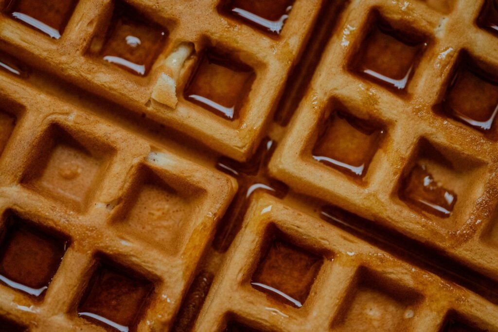 Golden waffles with syrup in squares